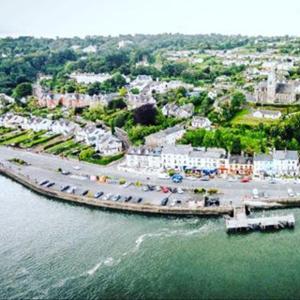 an aerial view of a beach with buildings and the water at The Bosun in Monkstown