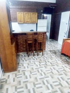 a kitchen with a counter and chairs in a room at Apartamento Agustín in San Bernardo