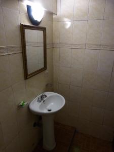 a bathroom with a white sink and a mirror at Hotel Montreal in Panama City