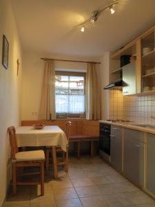 a kitchen with a table and a table and a window at Tuschnhof in Rinn