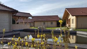 a garden with yellow flowers in front of houses at Sepp's Ferienhaus in Kirchham