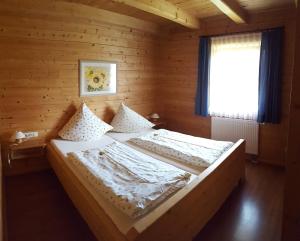 a bedroom with two beds in a wooden cabin at Sepp's Ferienhaus in Kirchham
