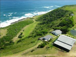 an aerial view of a house on a hill next to the ocean at Anglers Paradise in Eersterivierstrand