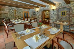 a dining room with wooden tables and chairs at Zamecka Fortovna Obora - Forester House in Kaznějov