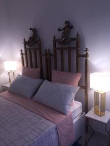 a bedroom with a large bed with two lamps at Le Case di Don Andrea in Minori