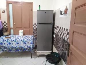 a kitchen with a table and a refrigerator at Chalet de la montagne in Ifrane