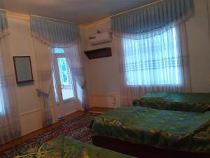 Cama o camas de una habitación en Guest House Nigina