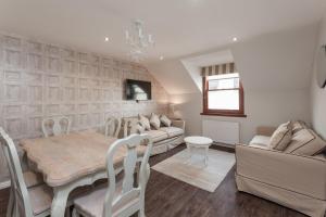 a living room with a table and a dining room at City Retreat Edinburgh ApartHotels in Edinburgh