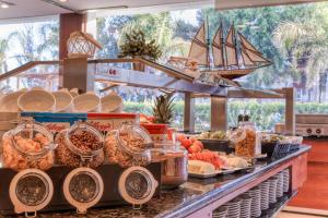 a buffet with food on a counter with a pirate ship in the background at Puertobahia & SPA in El Puerto de Santa María