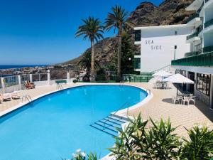 a large swimming pool on the roof of a building at The Green Terrace in Bajamar