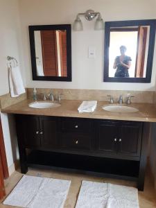 a person taking a picture of a bathroom with two sinks at Emerald Vista Villa in Vieux Fort