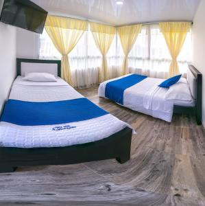 A bed or beds in a room at Finca Hotel La Molienda Quindiana