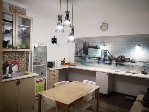 a kitchen with a table and a counter top at The Place Astana Hostel in Astana