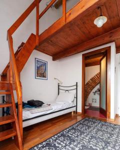 a bedroom with a bunk bed and a ladder at Eleonora Room & Breakfast in Oristano