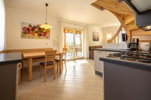 a kitchen and dining room with a table and a dining room at Haus Winkler in Vilpiano