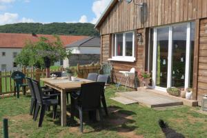 a wooden table and chairs in a yard with a house at Haus Süskewiet in Peffingen