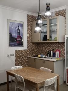 a kitchen with a table and chairs and a red bus at The Place Astana Hostel in Astana