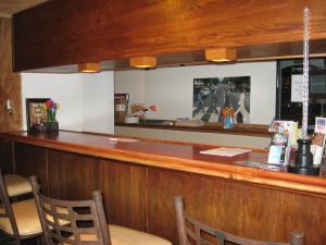 a bar in a restaurant with a mirror at RK Hostel in San Diego