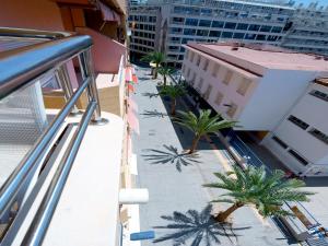 a view of a balcony with palm trees on a building at Apartamentos Maja in Benidorm
