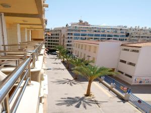 a view of a balcony with palm trees and buildings at Apartamentos Maja in Benidorm