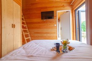 a room with a bed with a tray of flowers on it at Le Moulin in Martres-Tolosane