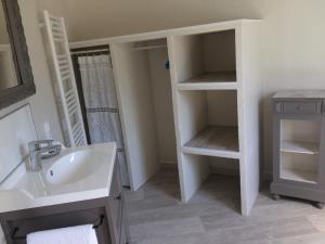 a white bathroom with a sink and a mirror at L'ATELIER JONQUERETTES in Jonquerettes