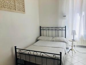 a bedroom with a black bed with a lamp on a table at Cinque terre SUITE in La Spezia