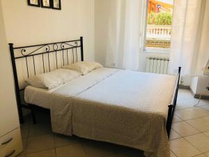 a bed in a bedroom with a window at Cinque terre SUITE in La Spezia