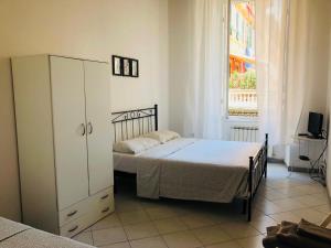 a bedroom with a bed and a cabinet and a window at Cinque terre SUITE in La Spezia