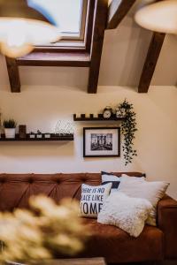 a living room with a brown couch and a window at N95 in Bitola