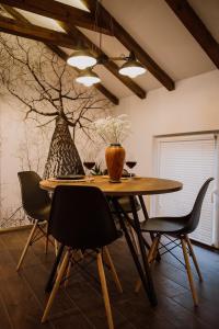 a dining room table with chairs and a vase on it at N95 in Bitola