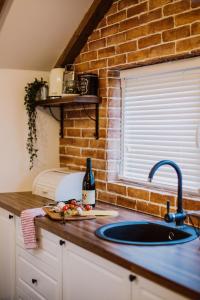 a kitchen with a sink and a brick wall at N95 in Bitola