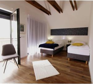 a bedroom with two beds and a chair at B&B Villa Dolina Plitvice in Plitvička Jezera +45 photos