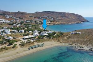 an aerial view of a beach with a blue arrow at Nostos Beachfront Apartments & Studios in Agios Ioannis