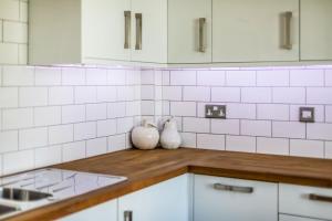 a kitchen with white appliances and white tiles on the wall at The i360 flat, penthouse, sea view, large private roof terrace, central Brighton 2 bedroom, up to 6 guests in Brighton & Hove +50 photos