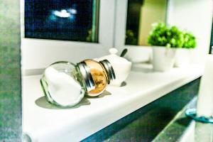 a bathroom counter with a mirror and a sink at JULIUSZ in Sandomierz