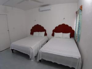 Postel nebo postele na pokoji v ubytování Habitaciones Chiquil Ha