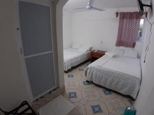 Postel nebo postele na pokoji v ubytování Habitaciones Chiquil Ha