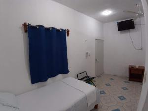 TV a/nebo společenská místnost v ubytování Habitaciones Chiquil Ha + 37 fotografií