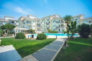 a large apartment building with a swimming pool at Sunrise Beach Club (Hera B6@) in Kalecik