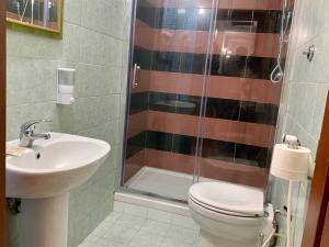a bathroom with a shower and a toilet and a sink at Casa Fanti 57 in Rome