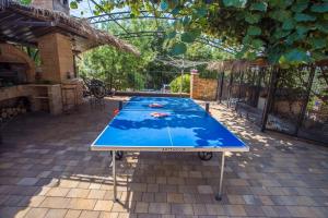 a ping pong table in the middle of a patio at Apartment Nova Vas/Porec 1 in Nova Vas