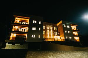 un edificio de noche con las luces encendidas en Gaudi Accommodation en Cluj-Napoca