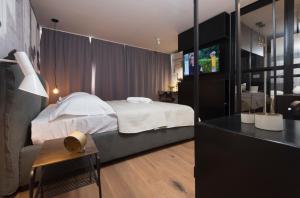 a bedroom with a bed and a television in it at Sibinicum luxury rooms in Šibenik