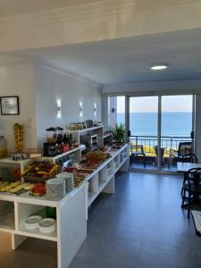 a buffet in a restaurant with a view of the ocean at Hotel Foxos in A Lanzada
