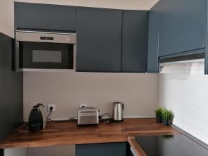 a kitchen with black cabinets and a counter top at Temple Suites Guesthouse in Portimão