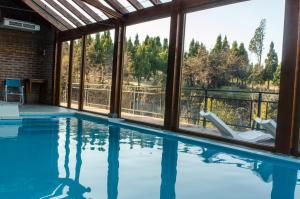 a swimming pool with a view of the trees at Arroyo Escondido in Trevelin