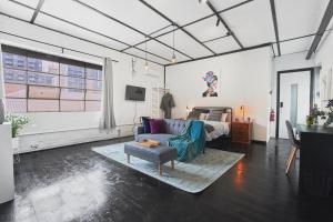 a living room with a couch and a bed at The Blender Loft in Melbourne