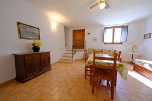 a living room with a table and a dining room at Agriturismo Montegonfoli in San Gimignano