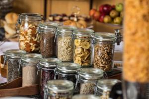 a group of jars filled with different types of nuts at Hotel Linderhof in Erfurt